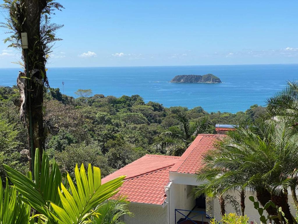 a view of the ocean from a house at Villa Roca Boutique Resort & Suites - ADULT ONLY in Manuel Antonio