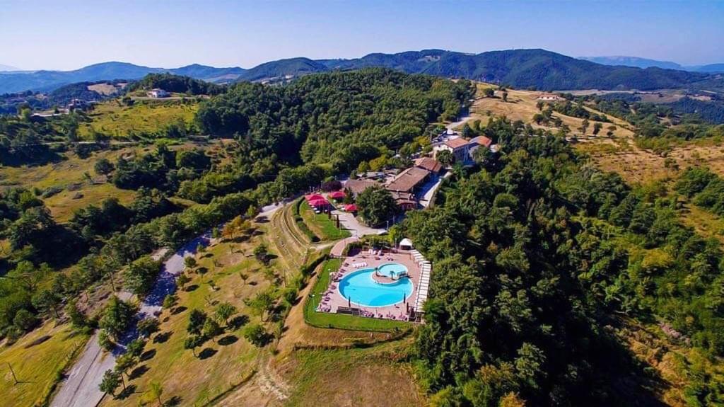 an aerial view of a house with a swimming pool at Faro Rosso in Montanaldo