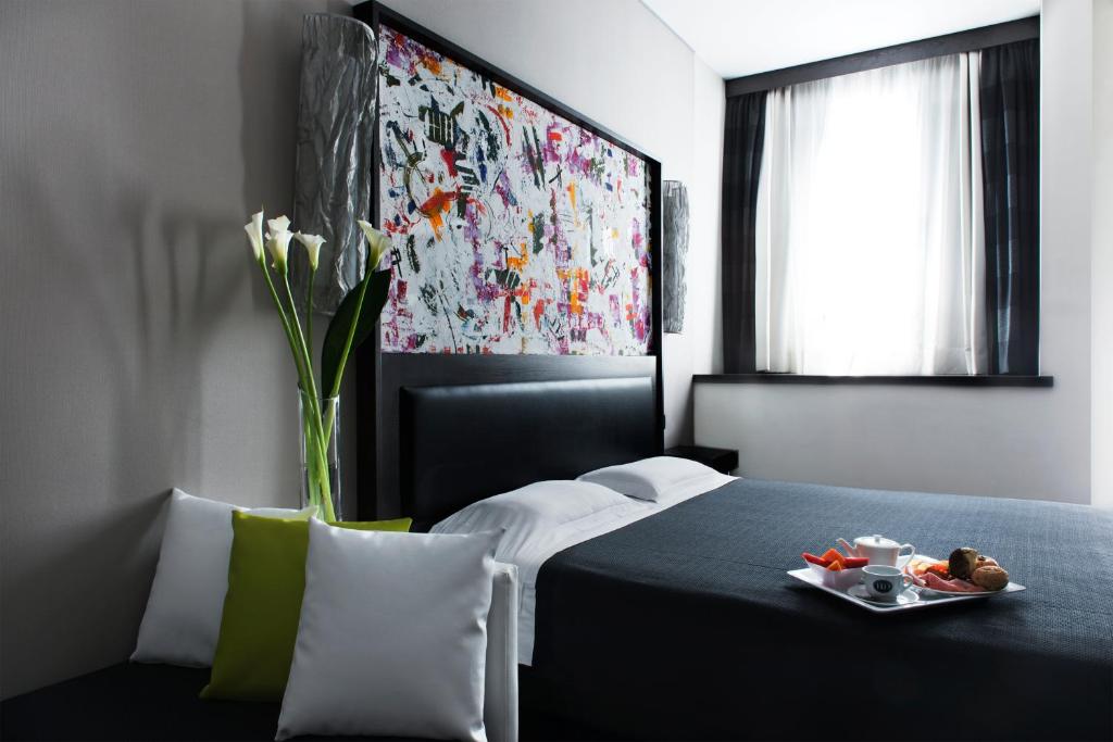 Postel nebo postele na pokoji v ubytování Twentyone Hotel