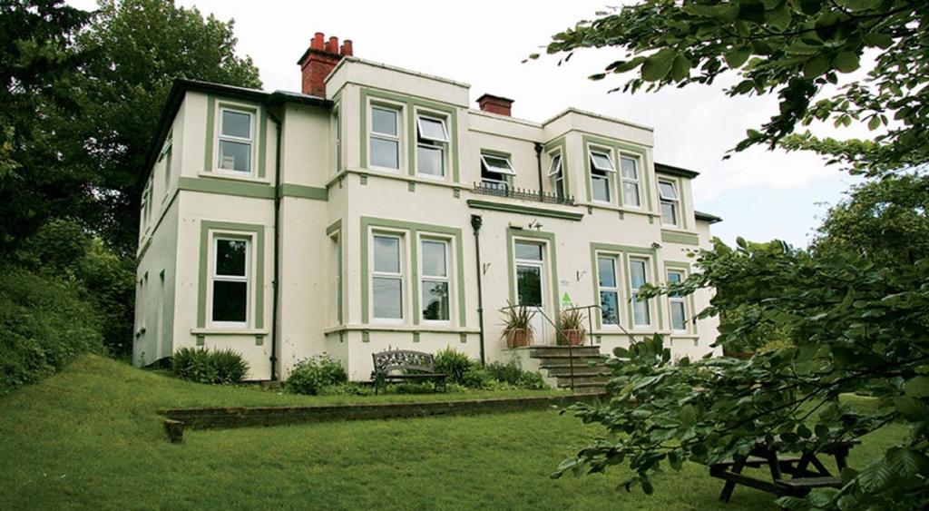 a large white house with a green yard at YHA Streatley on Thames in Streatley