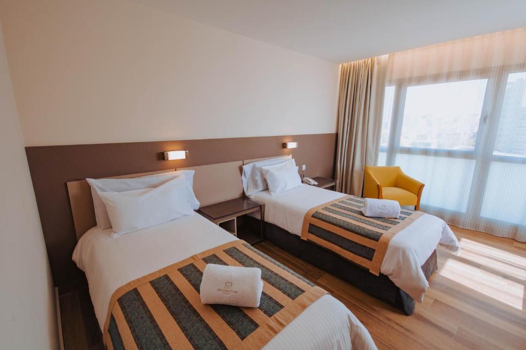 Postel nebo postele na pokoji v ubytování SEC Hotel