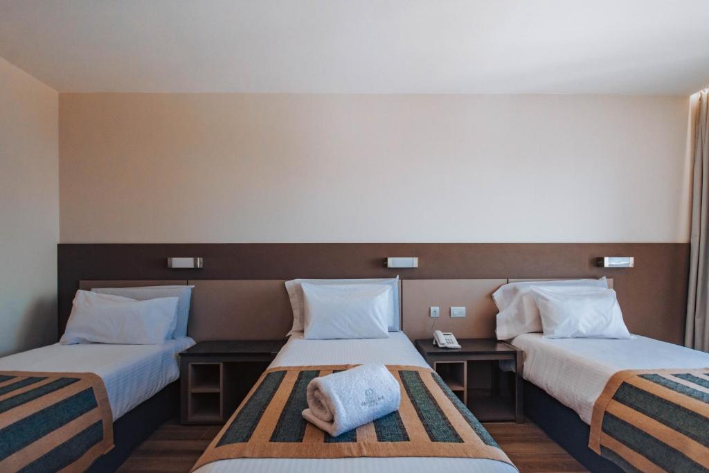 Postel nebo postele na pokoji v ubytování SEC Hotel