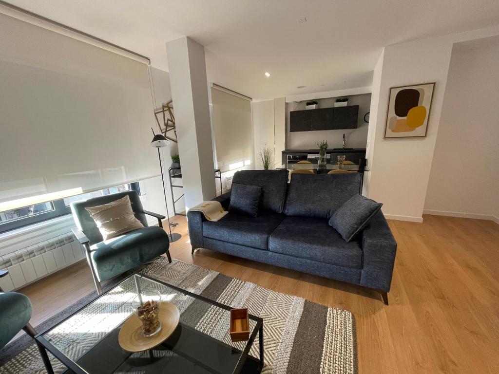 een woonkamer met een bank en een stoel bij Oktheway Areal Terrace in Oleiros