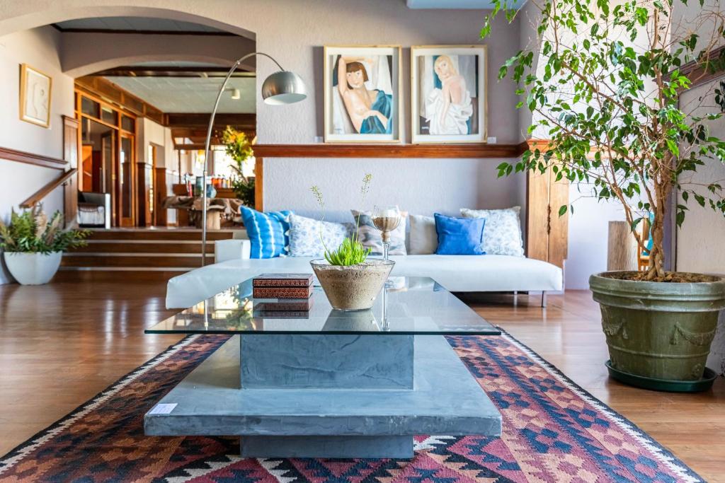a living room with a couch and a table at Punta del Este San Marcos Eco Hotel in Punta del Este