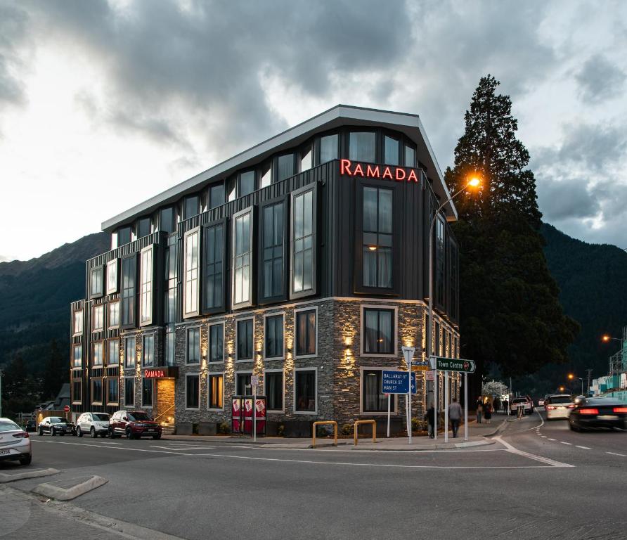 a building with a sign on the side of it at Ramada Queenstown Central in Queenstown