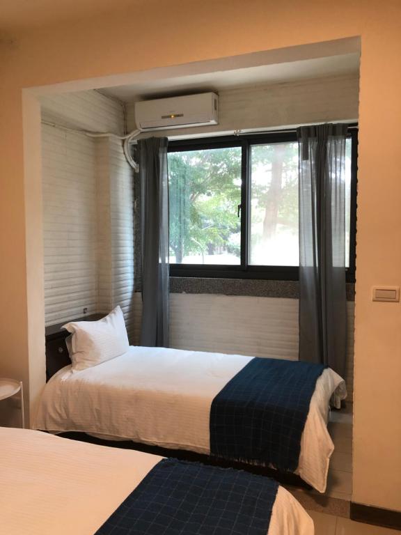 Postel nebo postele na pokoji v ubytování Yi Jia Homestay