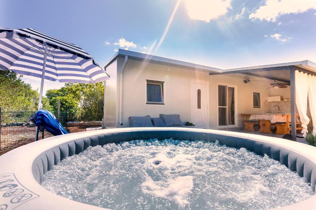 a hot tub in the backyard of a house at House Green Oasis in Vodice