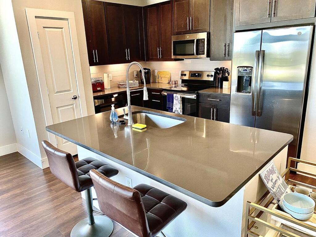 a kitchen with a large island in the middle of it at Beautiful 3 Bedroom Apartment in Bryan