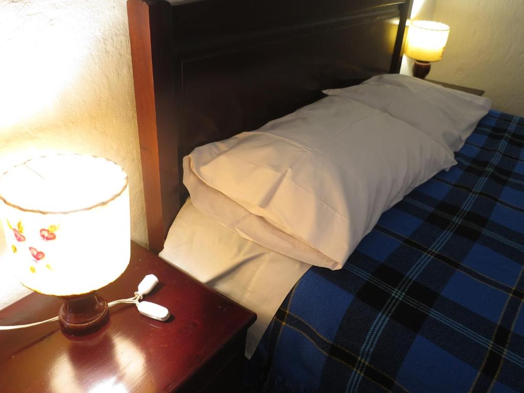 Postel nebo postele na pokoji v ubytování Hostal La Cazihita