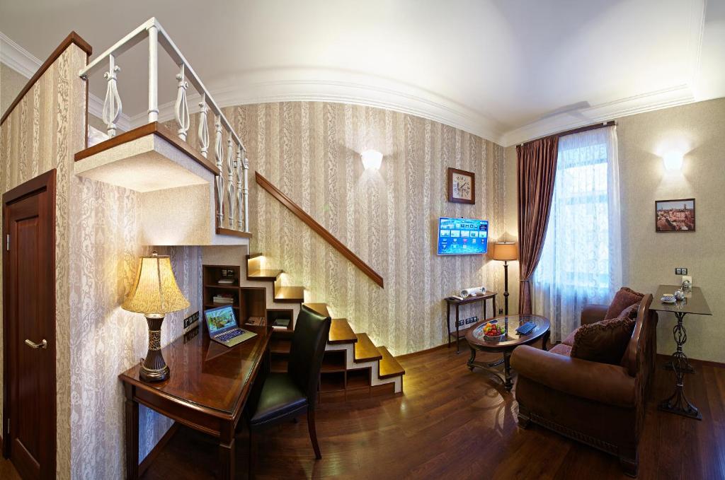 a living room with a staircase in a house at Apartment on Zagorodny avenue 22 in Saint Petersburg