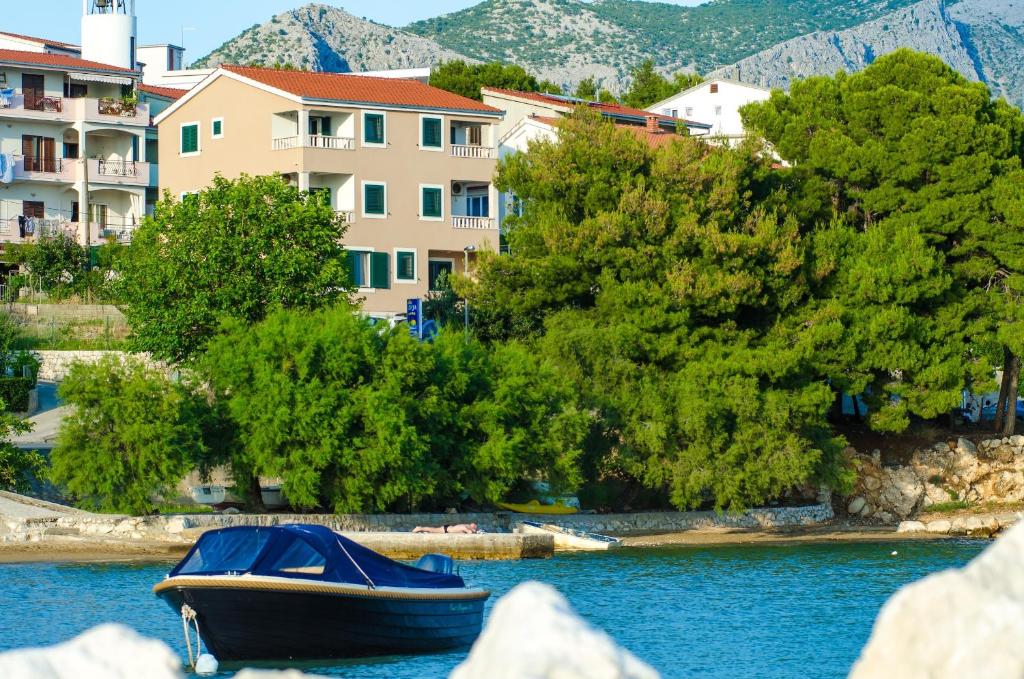 a boat sitting on the water in front of buildings at Villa Lidija in Omiš