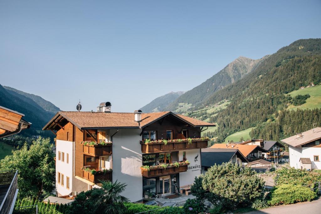 a town in a valley with mountains in the background at Hotel Wildschütz in San Leonardo in Passiria