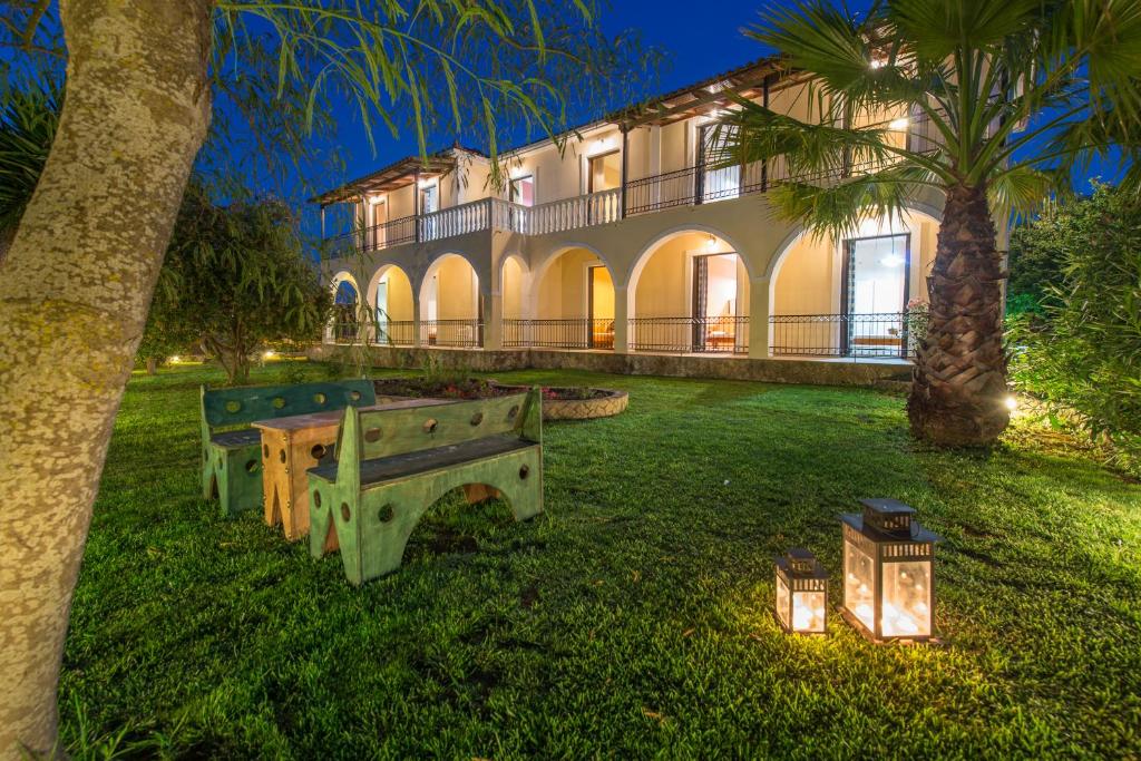 a building with a park bench in front of it at Helen & Theo Studios in Laganas