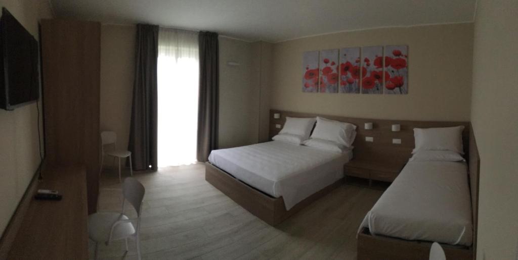 Postel nebo postele na pokoji v ubytování TERRAZZA Rooms