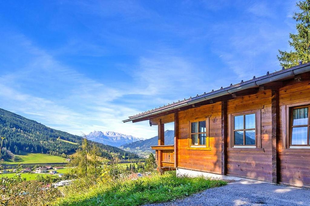 a wooden cabin with a view of the mountains at Chalets in Eben im Pongau in Eben im Pongau