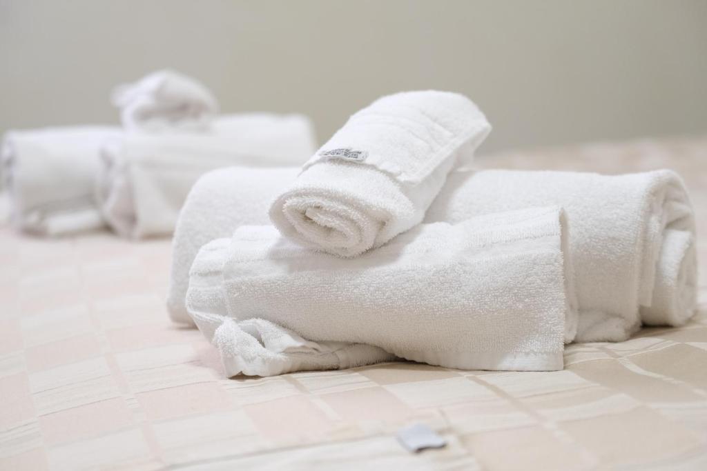 a pile of white towels sitting on a bathroom floor at B&B La Porta in Rome