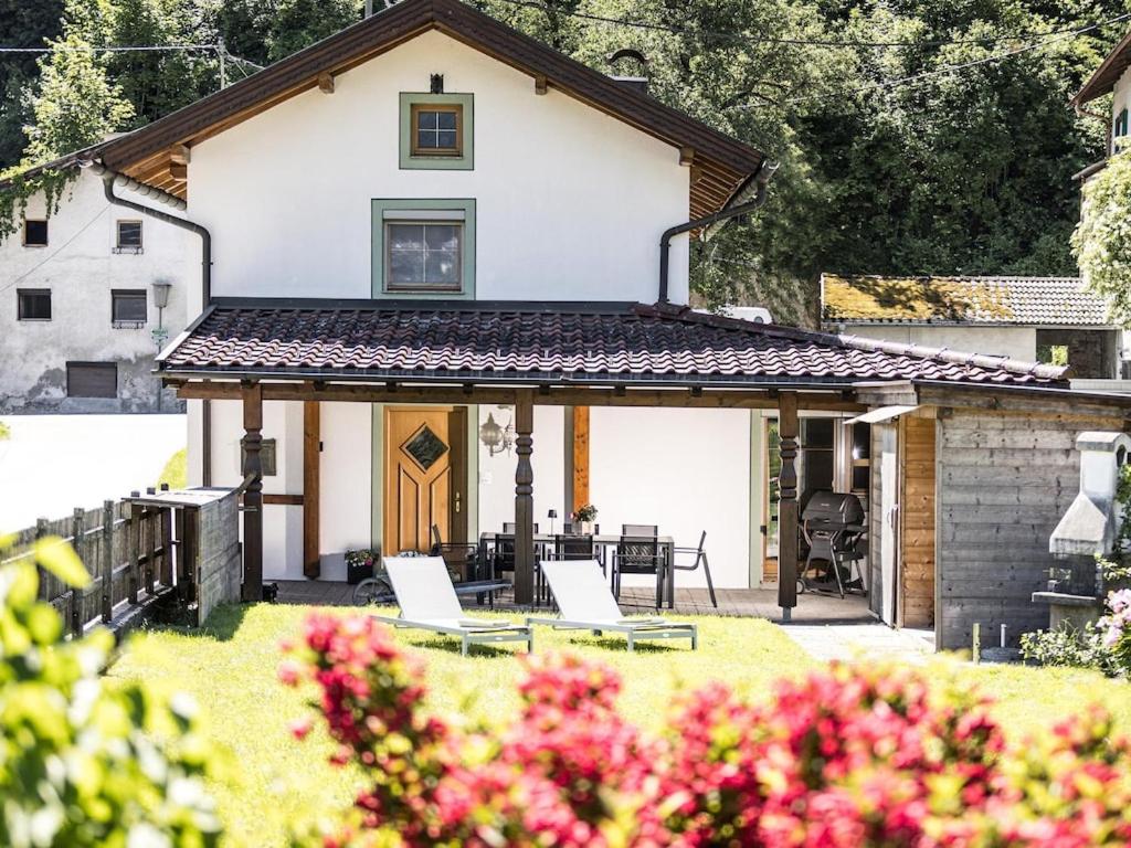 a house with a porch with two chairs in the yard at holiday home, Strass im Zillertal in Strass im Zillertal