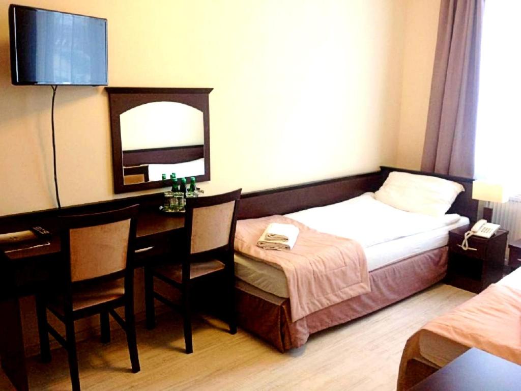 Posteľ alebo postele v izbe v ubytovaní Hotel Feniks