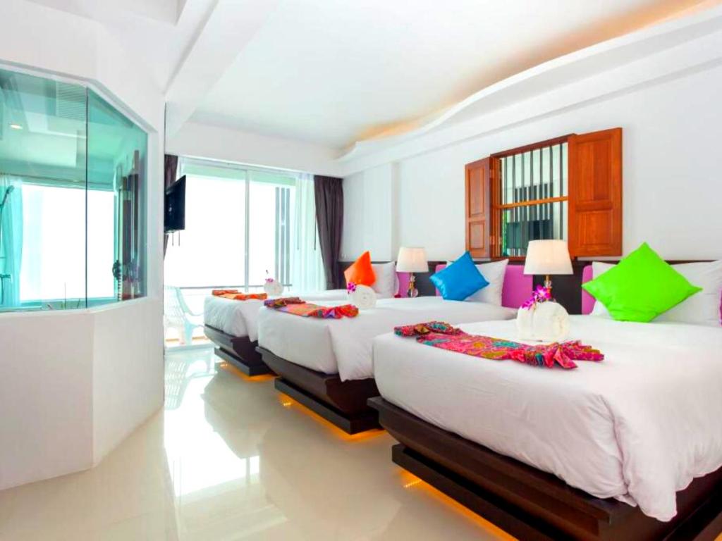 Postel nebo postele na pokoji v ubytování The Samui Beach Resort