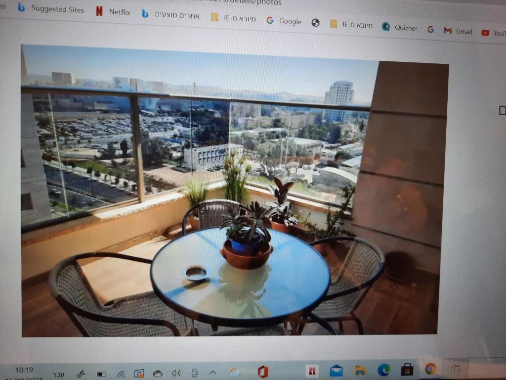 a picture of a table and chairs on a balcony at The Shining Star -A beautiful 3 bedroom apartment in Beer Sheva