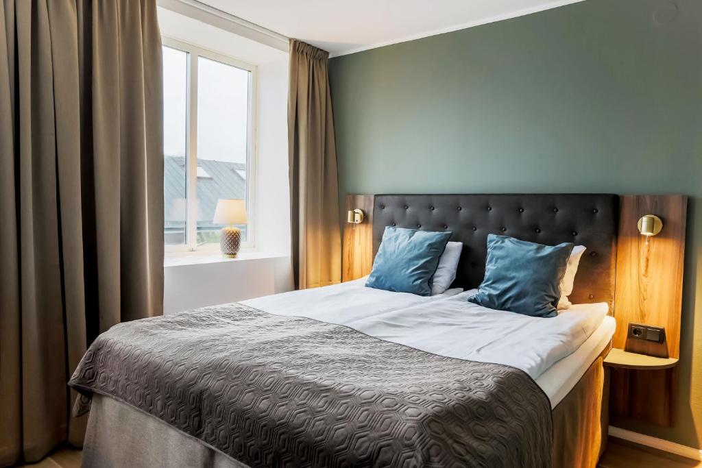 Postel nebo postele na pokoji v ubytování Home Hotel Cardinal