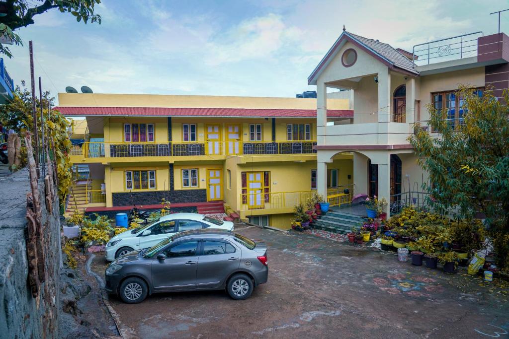 a car parked in front of a yellow building at MISBA HOMESTAY in Kodaikānāl