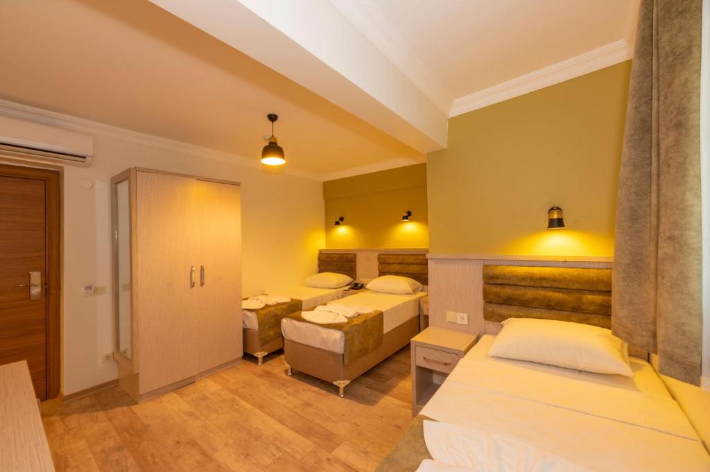 a hotel room with two beds and a hallway at Bazaar Hotels Old City in Istanbul