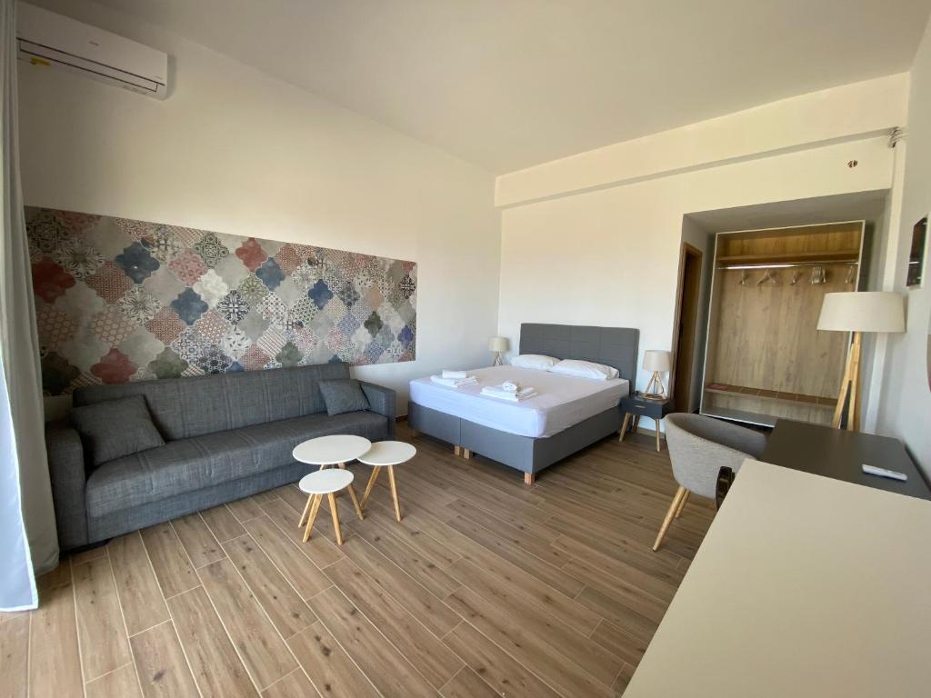 a living room with a couch and a bed at Blue Sky in Frangokastello