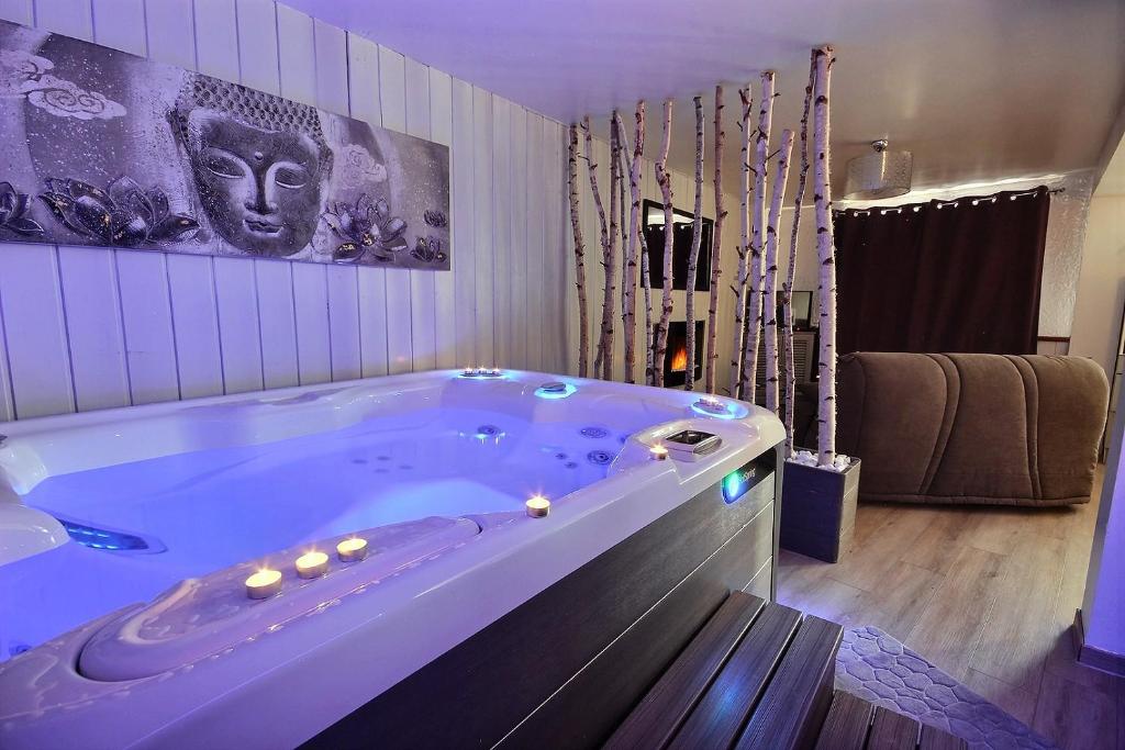 a large bath tub in a room with at Spa et romance à Molliebon in Séez