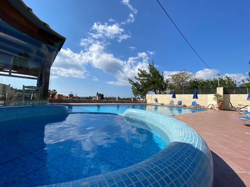 a swimming pool with a blue tiled swimming pool at Blue Sky in Frangokastello