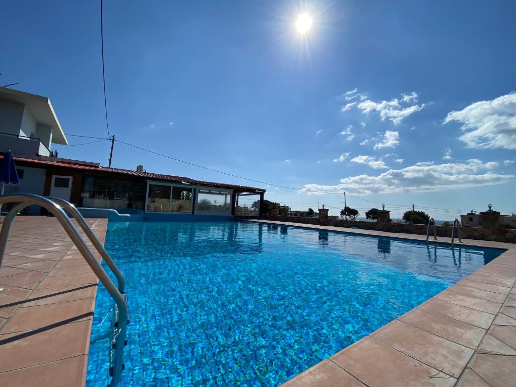 a large swimming pool with blue water at Blue Sky in Frangokastello