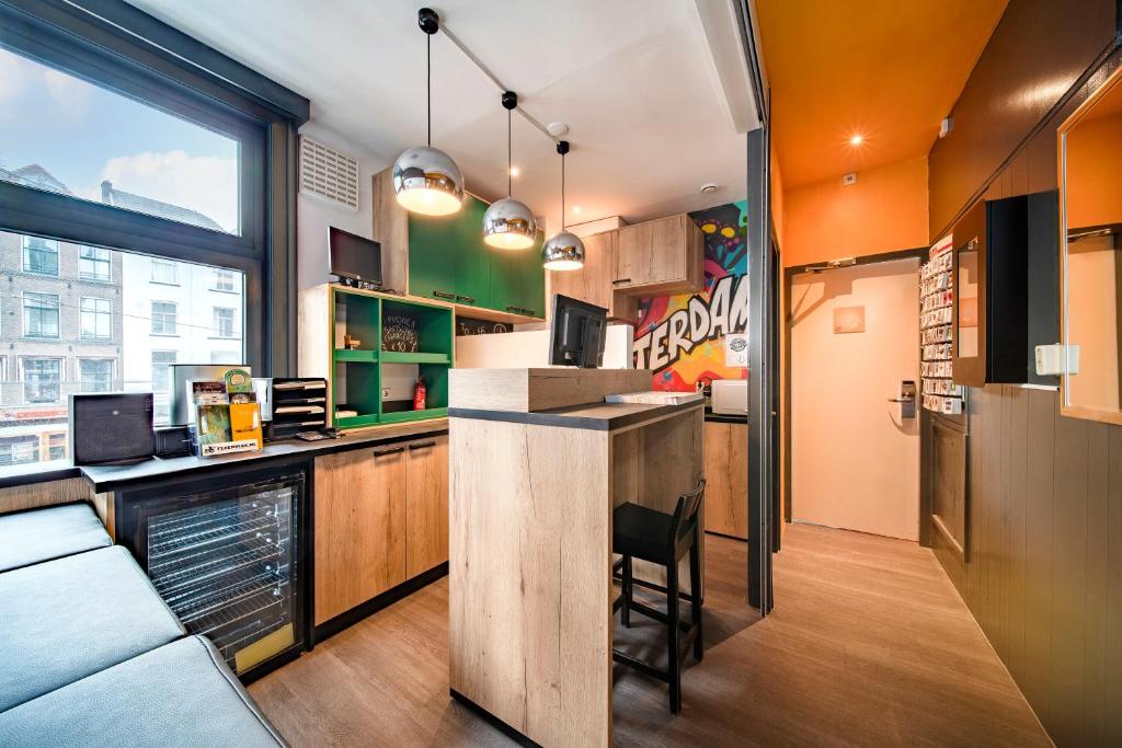 a kitchen with a counter and a bar in a room at Princess Hostel Leidse Square Amsterdam in Amsterdam