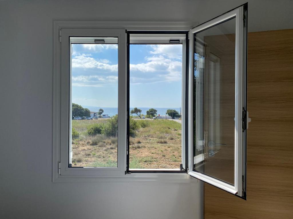 a window in a room with a view of a field at Blue Sky in Frangokastello