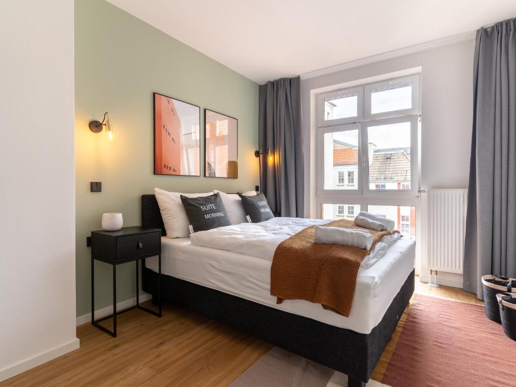 um quarto com uma cama grande e uma janela em limehome Erfurt Schmidtstedter Straße em Erfurt