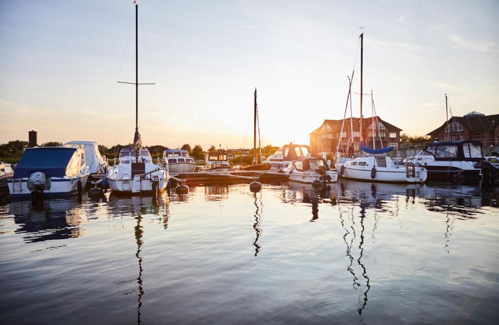 a group of boats are docked in a harbor at Bades Huk Marina Hotel in Hohen Wieschendorf