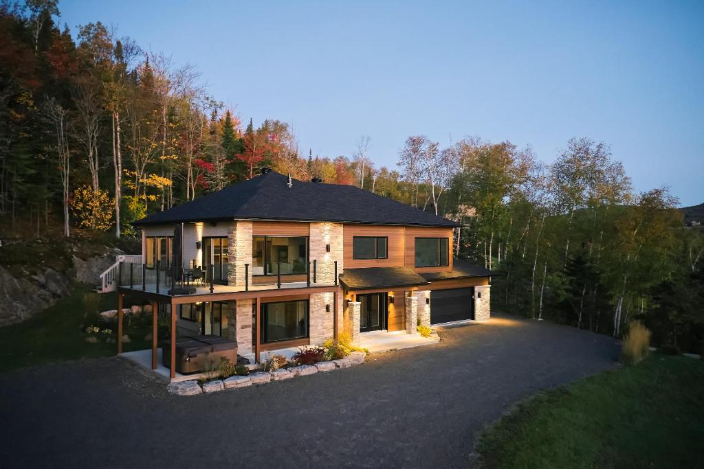 an aerial view of a house in the woods at Greystone - View - 4 King Beds - SPA - Pool Table - Fireplace in Les Éboulements