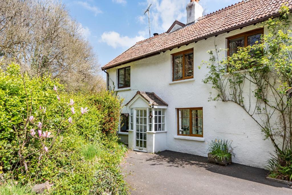 a white house with a pathway in front of it at Idyllic Country Cottage - Dog Friendly, 6 mins drive to Saunton Beach- World Class Surfing Reserve! 5 mins drive to Golf Course, REDUCED RATES! in Braunton