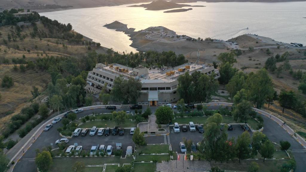 an aerial view of a building with a parking lot at Ashur Hotel in Dokan