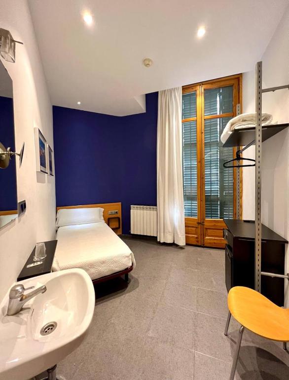 Postel nebo postele na pokoji v ubytování Hostal Apolo