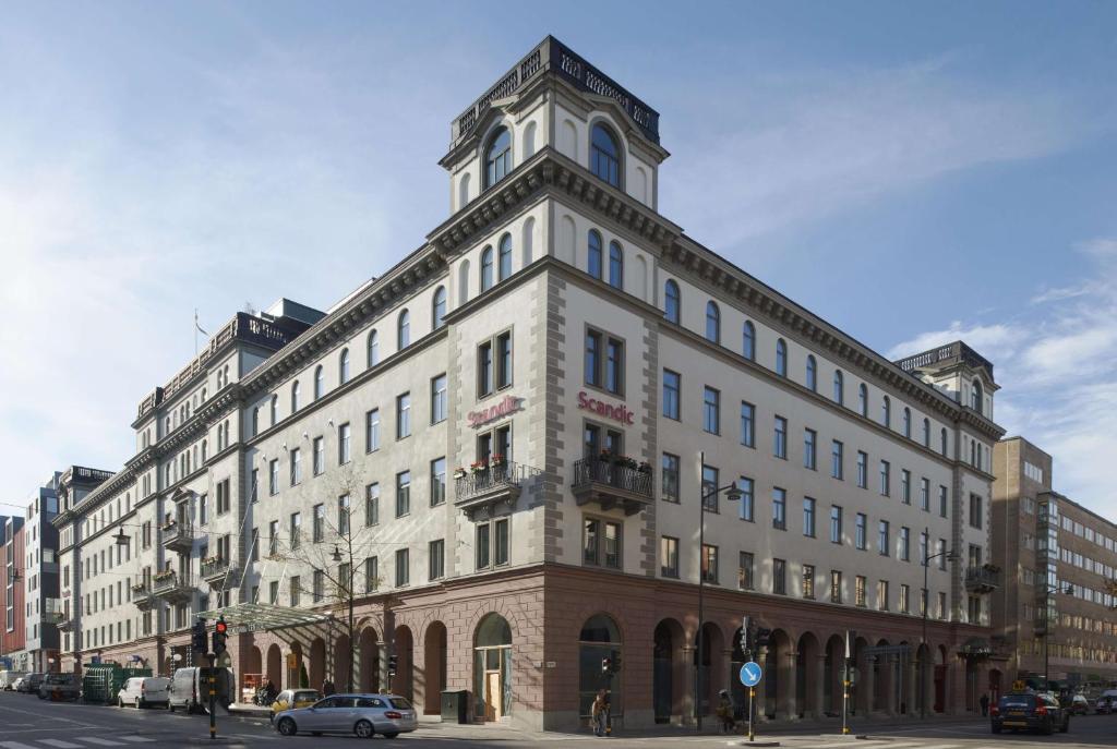 a large building with a clock on the front of it at Scandic Grand Central in Stockholm