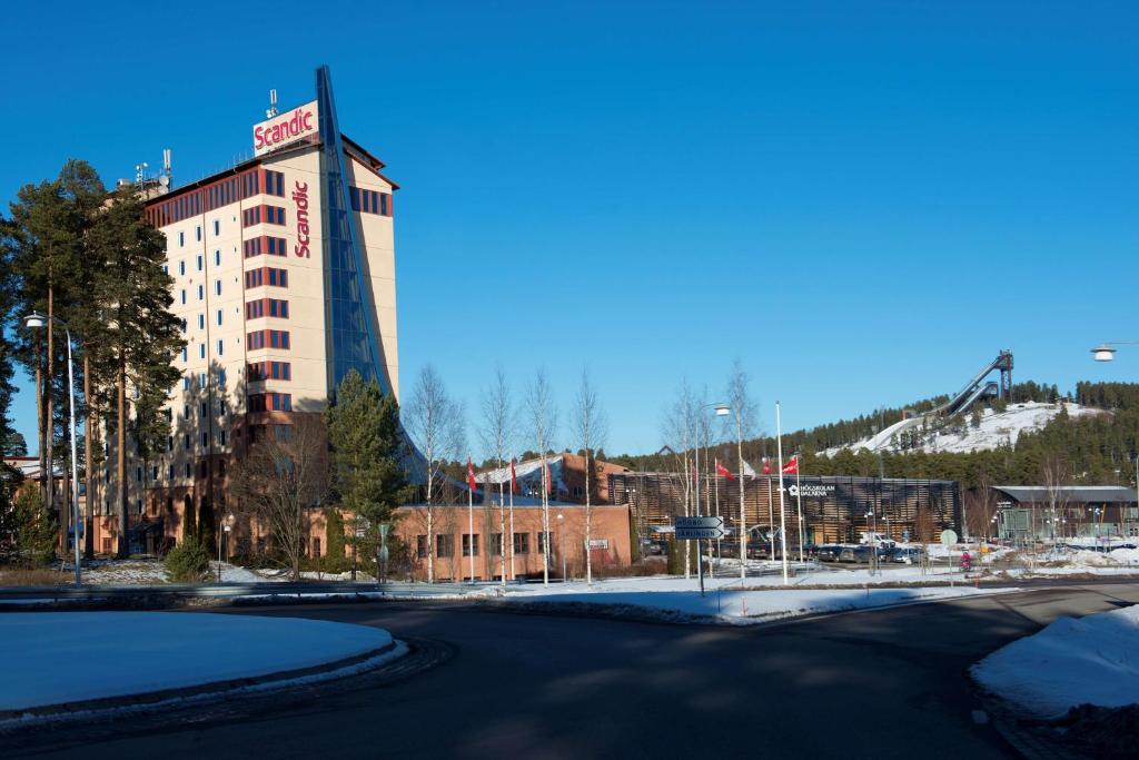 a building with a sign on the side of it at Scandic Lugnet in Falun