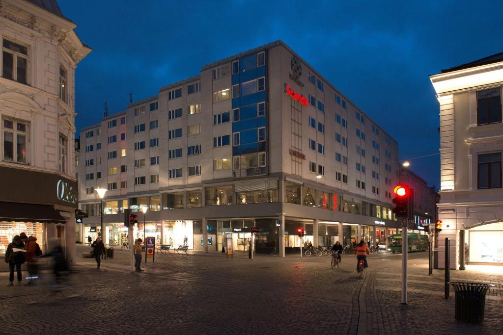 a large building on a city street at night at Scandic S:t Jörgen in Malmö