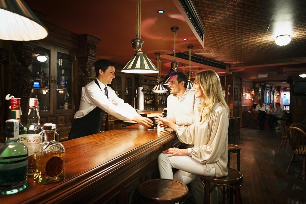 a group of people sitting at a bar at Royal Hideaway Sancti Petri in Chiclana de la Frontera
