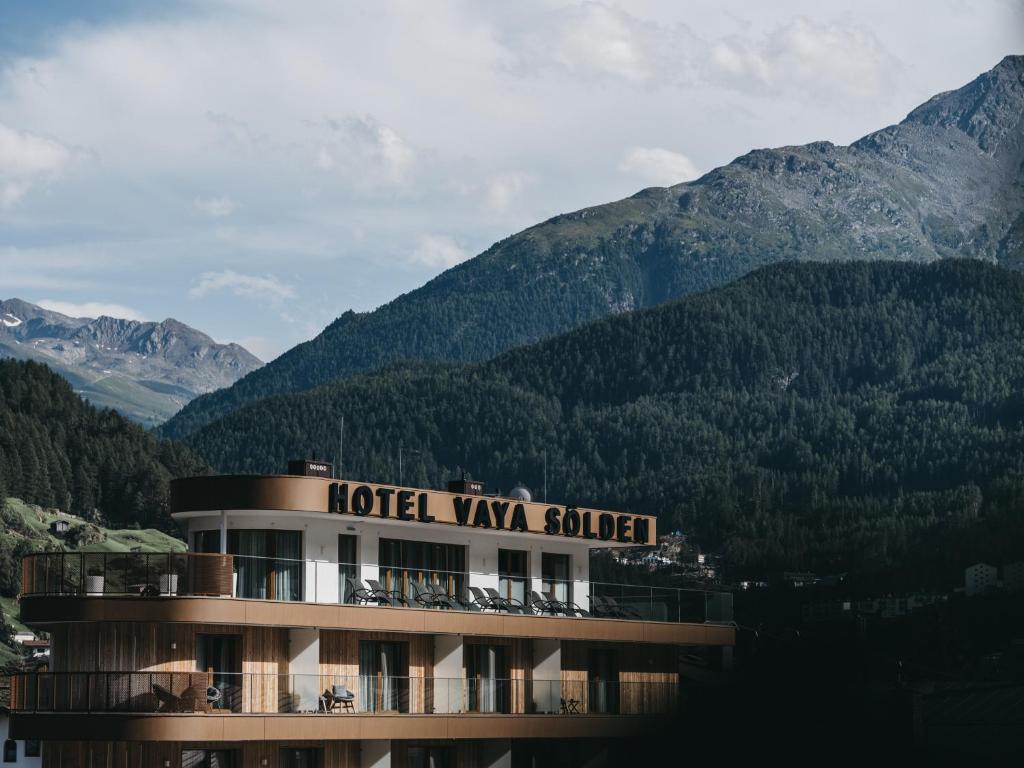 a hotel villa with mountains in the background at VAYA Sölden inklusive Summer Card in Sölden
