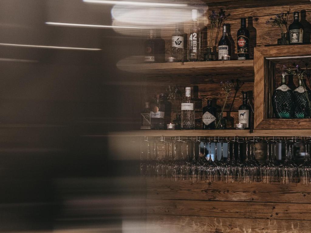 a bar with many wine glasses on the shelf at VAYA Sölden inklusive Summer Card in Sölden