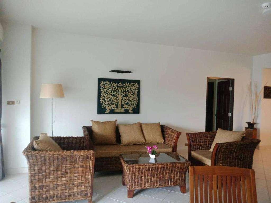 a living room with a couch and chairs and a table at Sandy Home in Ban Thai Don (2)