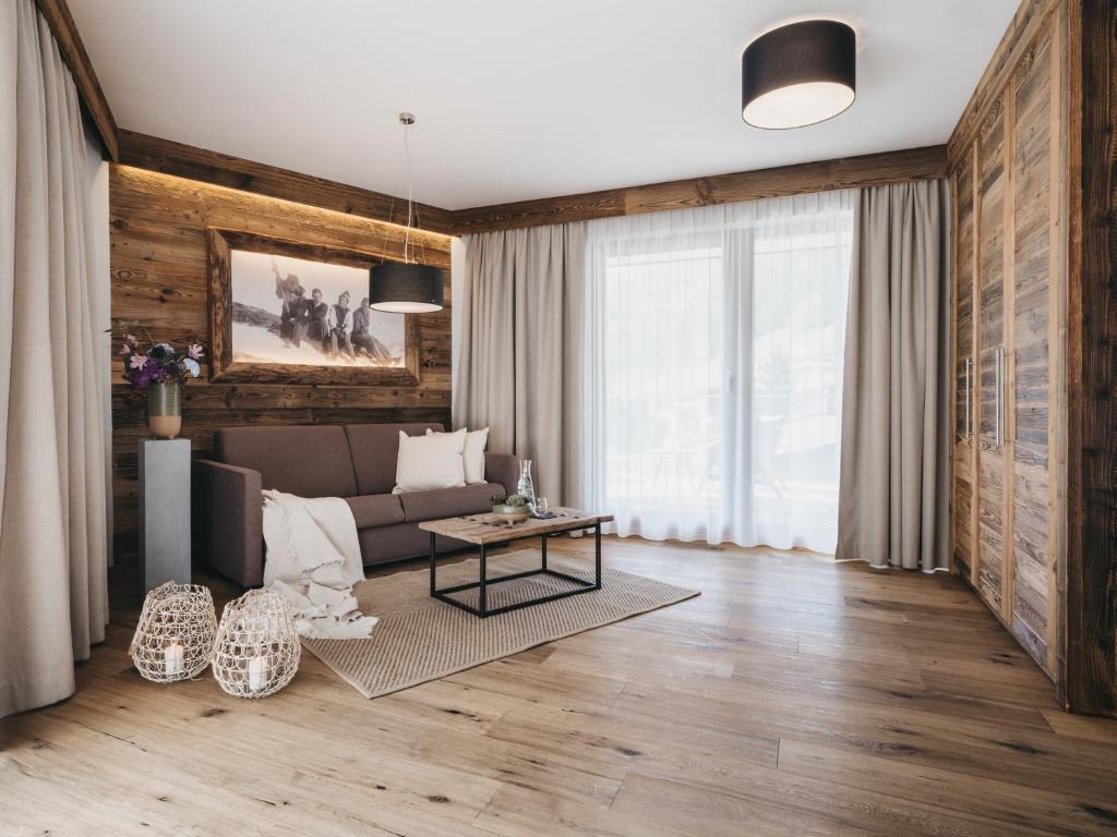 a living room with a couch and a table at VAYA Sölden inklusive Summer Card in Sölden