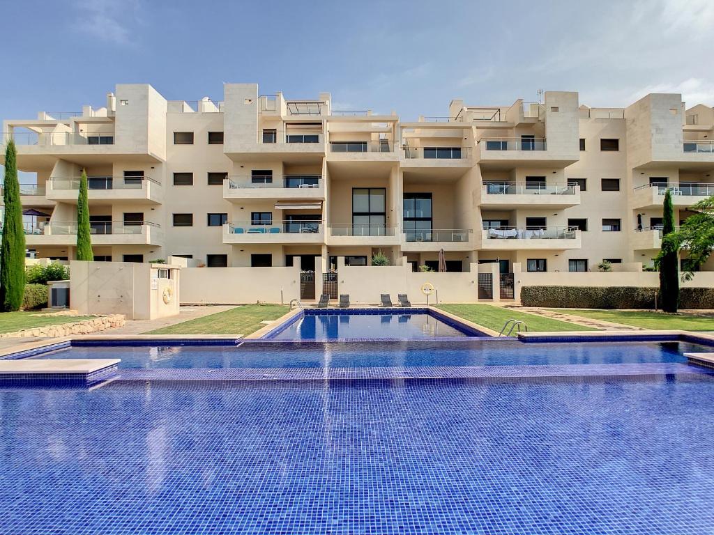 a swimming pool in front of a building at Jardines de Montesolana Penthouse - 2110 in Los Dolses
