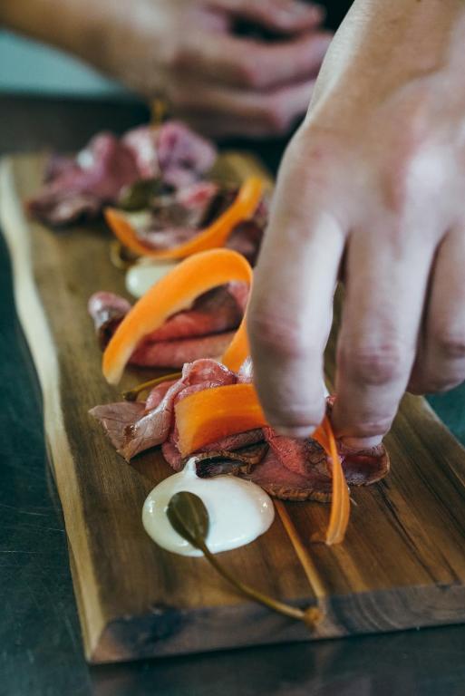 a person cutting up food on a cutting board at Masseria Borgo Santuri in Ostuni