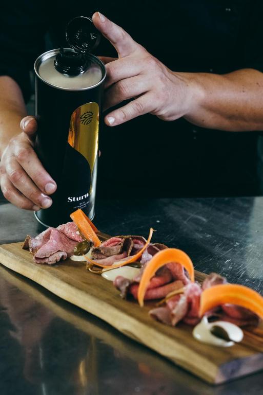 a person is cutting up meat on a cutting board at Masseria Borgo Santuri in Ostuni